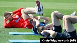 England soccer player David Beckham, left, performs core stability exercise during a training session at Royal Bafokeng Sports Complex where the England soccer team are based, near Rustenburg, South Africa, Friday June 4, 2010.