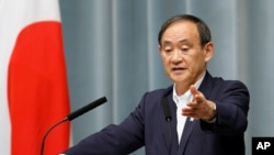 FILE - Japan's Chief Cabinet Secretary Yoshihide Suga speaks to VOA's Steven Herman, Tokyo, Japan, Feb. 4, 2013. 