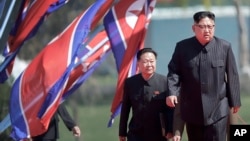  North Korean leader Kim Jong Un, right, and Choe Ryong Hae, vice-chairman of the central committee of the Workers' Party, arrive for the official opening of the Ryomyong residential area, April 13, 2017, in Pyongyang, North Korea. 