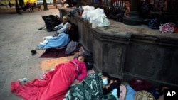 Migrants sleep under a gazebo at a park in the Mexican border city of Reynosa, March 27, 2021. 