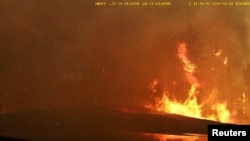 Smoke covers the road as wildfire burns in Hammonds Plains, Nova Scotia, Canada, May 28, 2023 in this screengrab obtained from a social media video. Instagram@alka.films/via REUTERS
