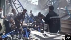 An image made from video posted online by the Shaam News Network, a loosely organized group opposed to Bashar Assad, Aug. 16, 2015, which has been verified and is consistent with other AP reporting, shows rescuers taking a victim from the site of Syrian government airstrikes in Douma.