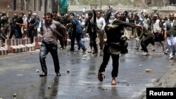 Afghans throw stones towards security forces during a protest in the wake of a deadly bombing Wednesday, in Kabul, Afghanistan, June, 2, 2017. 