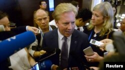 New Zealand's Trade Minister Todd McClay (center) is mobbed by reporters at the end of the meeting TPP11 (gathering all Tran-Pacific Pact member countries except the United States) held on the sideline of the Asia-Pacific Economic Cooperation meeting in Hanoi, May 21, 2017.