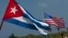 FILE - U.S. and Cuban flags fly. The countries re-established diplomatic relations earlier this year following a half century of estrangement.