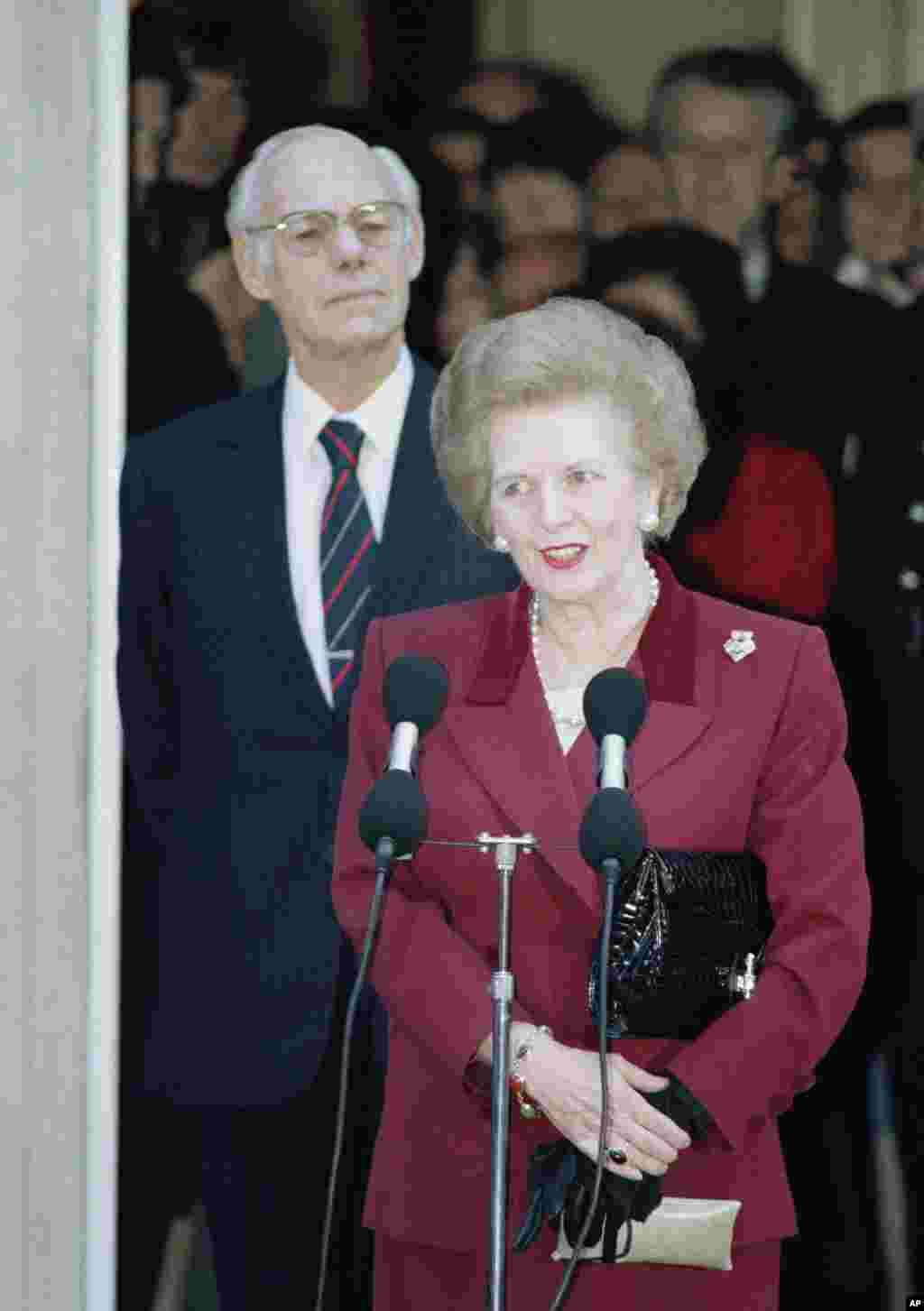 Margaret Thatcher made a statement to reporters as Denis Thatcher listens, as she left No. 10 Downing Street, Westminster for Buckingham Palace to resign as prime minister, Nov. 28, 1990.