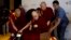 Tibetan spiritual leader, the Dalai Lama, center, is assisted by his aides as he arrives to interact with an audience of educators, in New Delhi, India, April 4, 2019.
