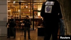 Israeli policemen secure the entrance to a restaurant following a shooting attack in the center of Tel Aviv, June 8, 2016. 