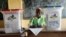 FILE - A election official writes as people cast their ballots during elections in Bangui, Central African Republic, Dec. 30, 2015. 