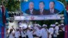 Supporters of Prime Minister Hun Sen's Cambodian People's Party dance under portraits of the party leaders, from left, Chea Sim, Hun Sen and Heng Samrin, during an election campaign in Phnom Penh, file photo. 