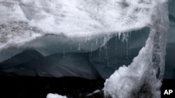Peru Melting Glaciers: In this Aug. 12, 2016 photo, a block of ice of Pastoruri glacier is melt. Tourist visit this glacier in a tour called "Route of climate change" in Huaraz, Peru.