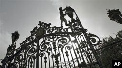 A worker makes repairs to a fence outside the People's Assembly as final preparations are made for the opening session January 23 of the first post-Hosni Mubarak parliament session, several days ahead of the one-year anniversary of Egypt's revolution, in 