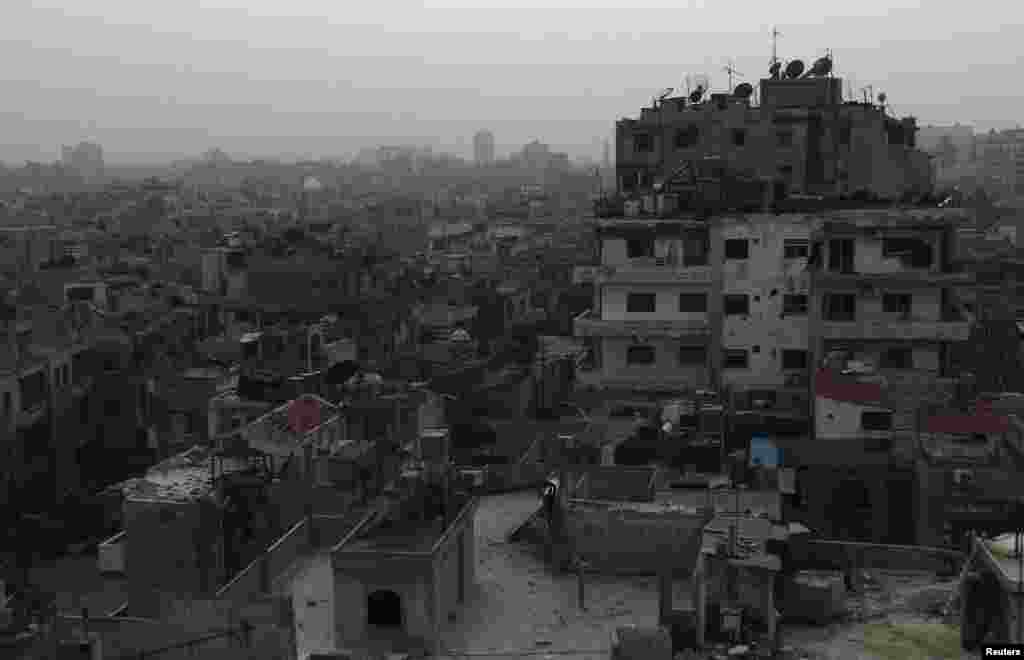 A general view of damaged buildings are seen in the besieged area of Homs, March 3, 2014.