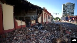 Debris from a collapsed wall of a building litters the ground after an earthquake struck Puerto Rico before dawn, in Ponce, Puerto Rico. 