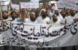 FILE - Pakistani Islamists protest the appointment of a minority Ahmadi Muslim as an adviser to the government, in Lahore, Pakistan, Sept. 7, 2018.