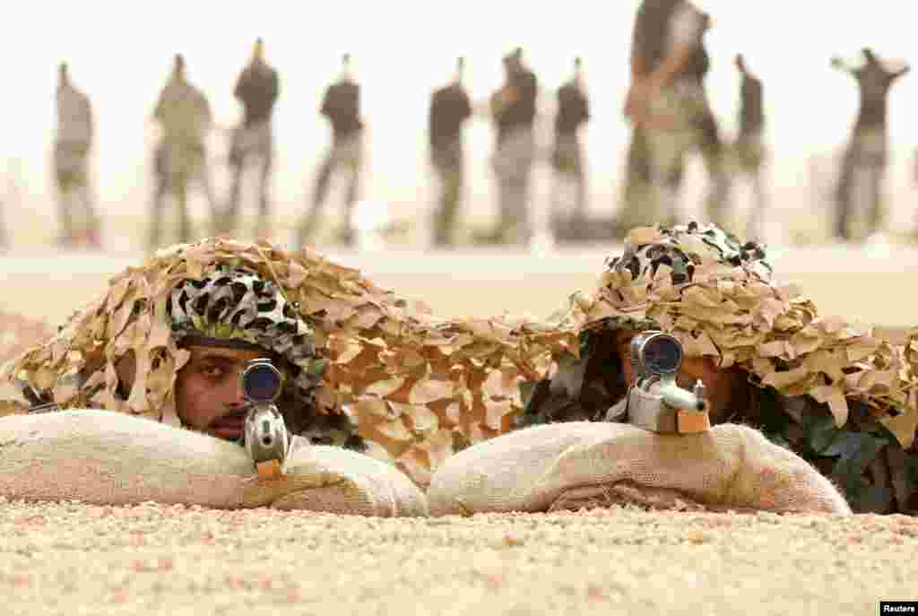 Members of Saudi special forces aim their guns during a training session in Darma, west of Riyadh, Saudi Arabia.