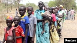 FILE - Residents displaced due to the recent fighting between government and rebel forces in the Upper Nile capital Malakal wait at a World Food Program (WFP) outpost where thousands have taken shelter in Kuernyang Payam, South Sudan, May 2, 2015. 