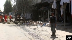 Municipality workers clean up at the site of a suicide attack in Kabul, Afghanistan, July 24, 2017.