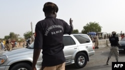 FILE - Chadian customs officers control traffic on the N'Gueli bridge, marking the border between Chad and Cameroon near N'Djamena, April 4, 2015. Traders and truck drivers took to the bridge Dec. 16, 2020, to protest COVID-imposed travel restrictions.