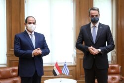 FILE - Greek Prime Minister Kyriakos Mitsotakis meets with Egyptian President Fattah el-Sisi at the Maximos Mansion in Athens, Greece, Nov. 11, 2020.
