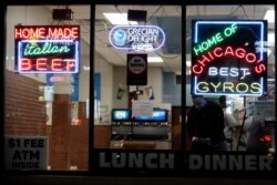 Customers order and wait for their food at a restaurant in Chicago, March 15, 2020.
