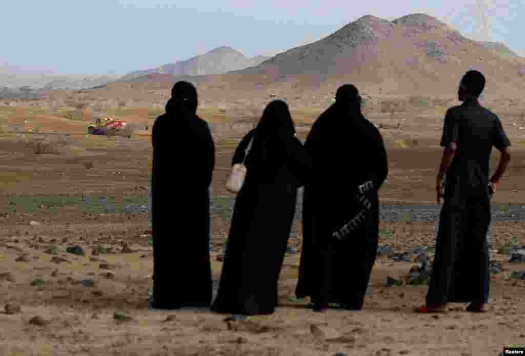 Locals look on during the shakedown stage at the annual Dakar motor rally in Jeddah, Saudi Arabia.