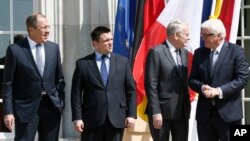 FILE - From left, Russia Foreign Minister Sergei Lavrov, Ukraine Foreign Minister Pavlo Klimkin, France Foreign Minister Jean-Marc Ayrault and German Foreign Minister Frank-Walter Steinmeier gather before talks in Berlin, Germany, May 11, 2016. 