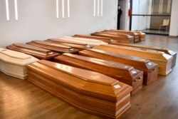Coffins are lined up on the floor in the Crematorium Temple of Piacenza, Northern Italy, saturated with corpses awaiting cremation due to the coronavirus emergency, March 23, 2020.