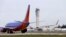 FILE - A Southwest Airlines jet waiting to depart in view of the air traffic control tower at Seattle-Tacoma International Airport in Seattle.