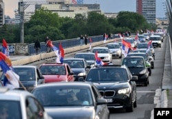 Cars fly the Serbian National flag as they drive through Belgrade in protest of the U.N.'s vote to establish an annual day of remembrance for the 1995 Srebrenica genocide, in Belgrade, on May 23, 2024.