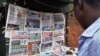 Newspapers with various front page headlines on the Chibok girls and their possible release are displayed at a news stand in Abuja Oct. 18, 2014.