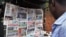 Newspapers with various front page headlines on the Chibok girls and their possible release are displayed at a news stand in Abuja Oct. 18, 2014.