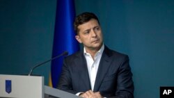 FILE - Ukrainian President Volodymyr Zelenskiy speaks during a meeting with law enforcement officers in Kyiv, Ukraine, July 23, 2019. 