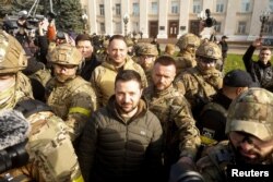 Ukraine's President Volodymyr Zelenskyy speaks to people after Russia's retreat from Kherson, in central Kherson, Nov. 14, 2022.