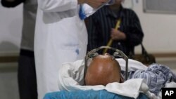 FILE - A stereotactic device presses into the head of a brain surgery patient at Ruijin Hospital's functional neurosurgery center in Shanghai, Oct. 29, 2018. Doctors at Ruijin are experimenting with deep brain stimulation as a treatment for addiction. 