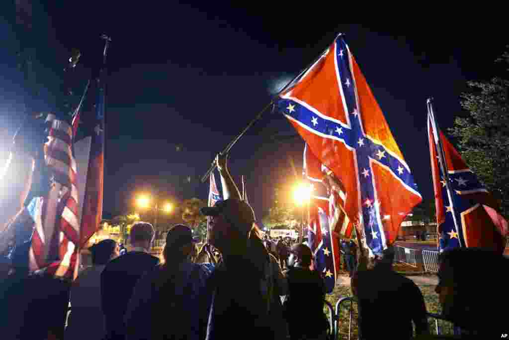 Demonstrators in support of keeping Confederate-era monuments protested before the Jefferson Davis statue was taken down in New Orleans, Louisiana.