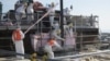 Workers are trying to remove unused nuclear fuel assemblies stored in the spent fuel pool tsunami-crippled Fukushima Daiichi Nuclear Power Plant No. 4 reactor building, July 19, 2012.