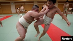 Kyuta Kumagai, 10, practices sumo with a boy at Komatsuryu sumo club in Tokyo, Japan, August 23, 2020. (REUTERS/Kim Kyung-Hoon)