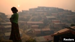 FILE - A Rohingya woman is seen at Balukhali refugee camp at dawn near Cox's Bazaar, Bangladesh, March 28, 2018. 