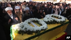 Mourners pray in front of the coffin of a civilian woman, Samar al-Sayyed Mohammed, who was killed by an Israeli airstrike in Bint Jbeil, Lebanon, on Jan. 22, 2024.