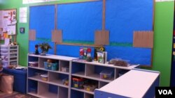 Cereal boxes are reused to make house fences at St. James school in Potomac, Maryland. (Photo: VOA / K. Amkas)
