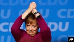 FILE - German Chancellor Angela Merkel acknowledges the applause of the delegates during the party convention of the Christian Democratic Union CDU in Berlin, Germany, Feb. 26, 2018.