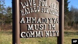 FILE - A sign bearing the words "Love for all, hatred for none" stands outside a mosque in Meriden, Connecticut, Feb. 27, 2016. Hafiz Abdul Hannan, the leader of the Masjid Al-Islam mosque in New Haven, Connecticut, was detained Tuesday and faces deportation to Pakistan.