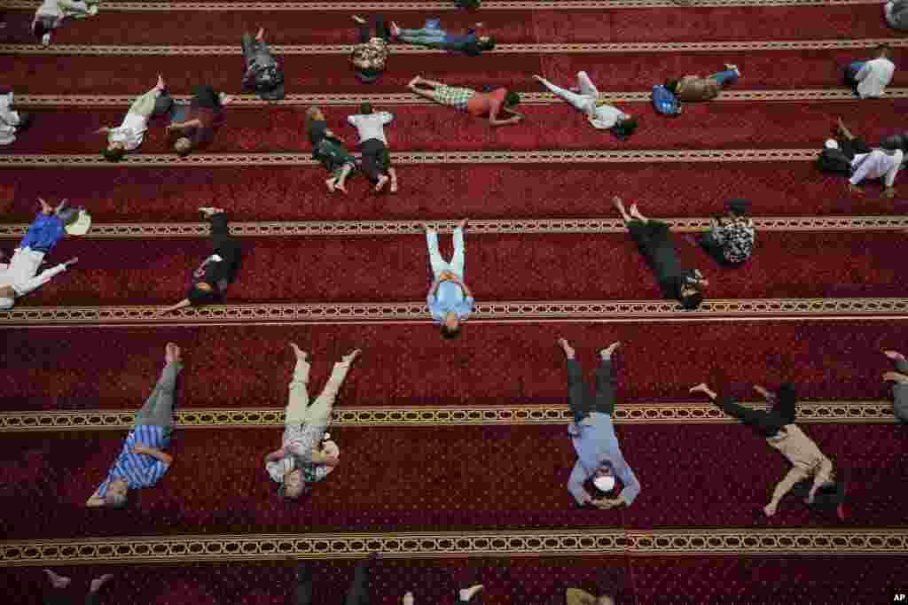 Muslim men rest after the first Friday prayer of the fasting month of Ramadan at Istiqlal Mosque in Jakarta, Indonesia.