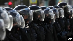 FILE - Police block a street during an unsanctioned rally in the center of Moscow, Russia, Aug. 3, 2019.