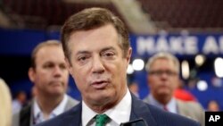 FILE - Paul Manafort, who at the time was chairman of Donald Trump's 2016 presidential campaign, talks to reporters on the floor of the Republican National Convention at Quicken Loans Arena in Cleveland, July 17, 2016.