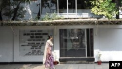 FILE - A woman walks past the former residence of Bangladesh’s 'founding father' Sheikh Mujibur Rahman, which is now a museum, in Dhaka, Bangladesh, Nov. 17, 2009.
