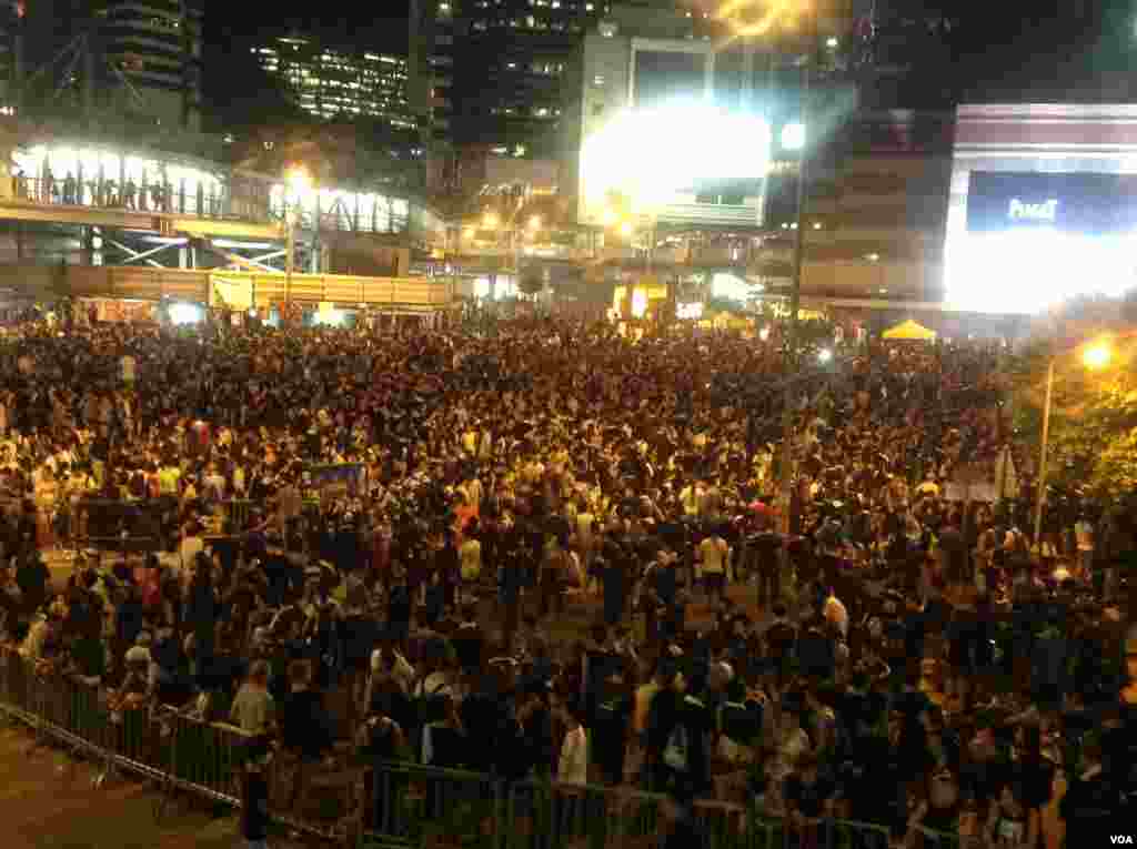 Protesters block the main street to the financial district outside the government headquarters in Hong Kong, Sept. 29, 2014. 