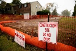 FILE - A sign is posted at a construction site on the Mariner East pipeline in a residential neighborhood in Exton, Pa., Oct. 22, 2019.