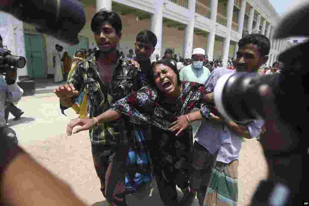 A woman cries after she identified her relative's body that was recovered from the rubble of a collapsed garment factory building, Savar, Bangladesh, May 3, 2013.